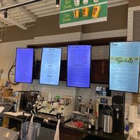 Screen menus behind the counter at The Remedy Exchange in Wakefield