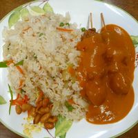 Fried rice with peanuts and veggie sate skewers in peanut sauce at Jade-Imbiss in Dusseldorf