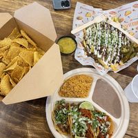 Taco plate (Carne asada and al pastor), Carne Asada fries, Chips and queso   at Nissi Vegan in Austin