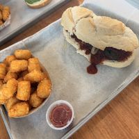 Meatball sub with tater tot’s. It isn’t even cut evenly!   at St. Veg in Rockville