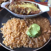 Vegan mock chicken enchilada with refried beans at Gringo Vibes in Northcote