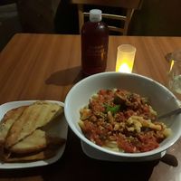 Macaroni with vegan sausage and tomato sauce with a side of garlic bread. at Leafy Greens Cafe in St Petersburg