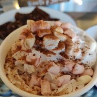 coconut hot chocolate with marshmallows and cream!! at Roots & Shoots Cafe in Bath