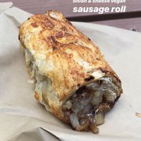 Caramelised onion sausage roll  at Roots & Shoots Cafe in Bath