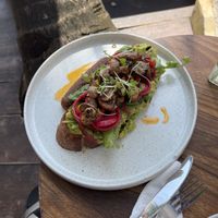 Vegan avocado toast with mushrooms and a vegan sausage  at Salty Swami's in Hikkaduwa