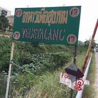 Sign from Street in Front and behind train Tracks at Mhee Yim Vegetarian Food in Hua Hin