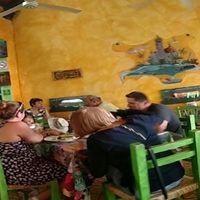 'Panorama' of interior taken with phone. Not shown: salad bar. Distortion due to first time use of panorama function! Included to show informality of the place. Food worthy of more formal dining, in my not-so humble opinion.  at Planeta Vegetariano in Puerto Vallarta