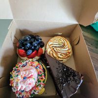 4 vegan desserts we grabbed to go. Berry tart, key lime tart, brownie chocolate cake, fun sprinkle chocolate cupcake.  All were amazing at Moondog in Key West