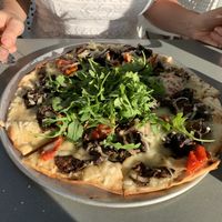 Roasted Mushroom, Truffle & Fontina:
mixed mushrooms, garlic, fresh herbs, vegan cheese, oil-cured tomatoes, truffle oil & arugula at Moondog in Key West
