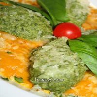 Home made spinach gnocchi and Sardinian ricotta served on top of a carrot squash creme sauce with orange Mediterranean herbs. 
 at Lei e Lui in Berlin