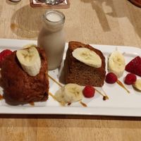 Dark rum and banana cake served with a little bottle of almond milk at South Causey Inn in Stanley