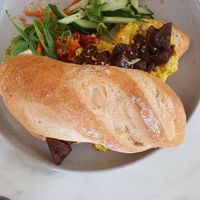 Avo scramble on semi-sourdough roll at Mettā Sol in Goodwood