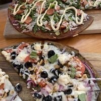 FREAKY GREEKY (bottom) and Samsara Sausage (top) on Cassava Homemade Roots Crust  at Vegan Cave Tanoor Pizza in Vancouver