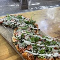 Vegan sausage and arugula pizza   at Vegan Cave Tanoor Pizza in Vancouver