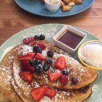 Pancakes with the ‘Chicken’ Burger in the background.  at Fuzzy Wombat's Kitchen in Port Noarlunga