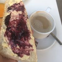 Coffee with oat milk and bread with margarine and jam  at Cafe Madrigal in Valencia