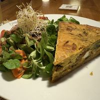 Spelt quiche with spinach, feta cheese, sun-dried tomatoes and sunflower seeds and salad  at Cafe Madrigal in Valencia