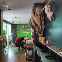 Seating inside with cow skull on the wall at Gartensalon in Munich