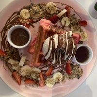 Notella waffles - with strawberries, bananas, granola and ice cream .   at Naked Bakery in Edinburgh