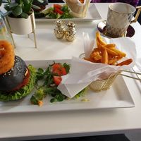 Cheese burger with onion rings, salad and chips at Naked Bakery in Edinburgh