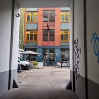 View of the outside of The Visit Coffee Roastery from the driveway into the courtyard at The Visit Coffee Roastery in Berlin