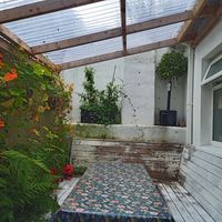 Outside covered seating area with open toilet window at Antiquity Plant-based Cafe @ The Timetravellers Bookshop in Skibbereen