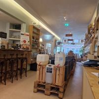 Inside shop- seating at the rear and bar at Little Plant Pantry in Amsterdam