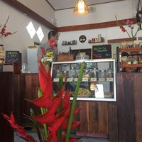 Beautiful flowers give the restaurant a lovely atmosphere with a cabinet full of lovely home baked biscuit  at Ganita Cafe in Pai