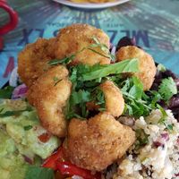 Burrito bowl with fried cauliflower + burrito in the back at Mez Factory in Lisbon