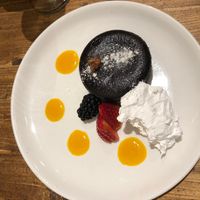 Chocolate fondant with berries, pineapple gel and cream at Gallo Santo in Barcelona