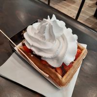 Belgian waffle with strawberries, chocolate and whipped cream at VeganWaf in Brussels