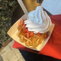 Waffle with whipped cream, maple syrup, and strawberries  at VeganWaf in Brussels