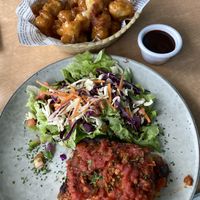 Battered cauliflower and lasagna with no cheese.  at Mika in Airlie Beach