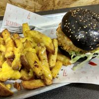 Buffalo burger with fries and cheese sauce on top. at Take A Veg in Dublin