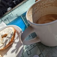Bagel with cream cheese and soy latte in a mug 🥳 at Just Bob in Portland