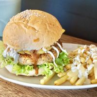 Handmade tempeh mushroom patty served on wholemeal bun with caramelized pineapple, special sauce, eggless mayo and air-fried fries at Pando Cafe in Kota Kinabalu