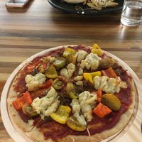 BBQ chicken pizza and black pepper burger in the background  at Pando Cafe in Kota Kinabalu