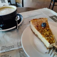 Matcha oat, vegan cheesecake and sunday newspaper at Grand Café Lochergut in Zurich