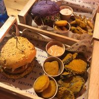 The flower burger (purple) and the funny cripsy (yellow) burgers. Nuggets, fried eggplant potatoe wedges at Flower Burger in Bari