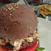 Falafel burger with an extra side of sweet potato fries. at Nourish in Hoi An