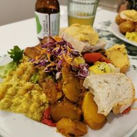 Buffet plate with chickpea curry, riasted veggies, smoked tofu, baked potatoes and more at Donna Veggie in Guimaraes