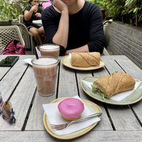 Chai latte, hummus sandwich, and a “roze koek”. All 100% vegan.  at De Roos in Amsterdam