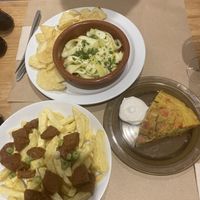 Noquerones (vegan anchovy - salty goodness), chorizo and fries, and great tortilla! Order it all!   at La Piparra in Bilbao