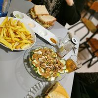 fries with 4 different sauces, tofu salad, vegan blt and a sandwich with cashew cheese and vegan chorizo at La Piparra in Bilbao