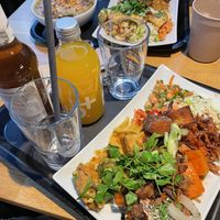 Sweet potato soup and two regular size plates wish a lot of mixed options from their menu  at Sattgrün Kolumba Viertel - Mitte in Cologne