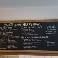 Menu on the wall  at One Happy Bowl in Noord