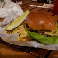 The impossible burger with vegan cheese..served with potato chips and a pickle. at Grills in Cape Canaveral