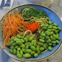Poke bowl with double edamame portion. DIY with zucchini noodles + quinoa base, with edamame as protein. Toppings: carrots, edamame and seaweed.  at El Boleo in Medellin