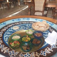 Selection of vegan mezzes with bread on our beautiful table. at Sofra in Luxor