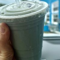 Blue spirulina smoothie with almond milk and  mango   at Zeke's Beans & Bowls in Norfolk